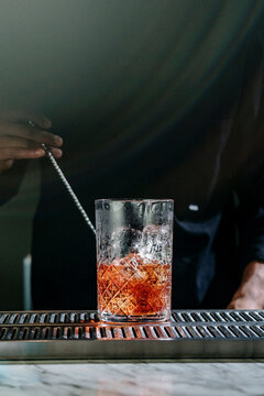 Elegant Negroni Cocktail on Marble Counter in Moody Bar Lighting