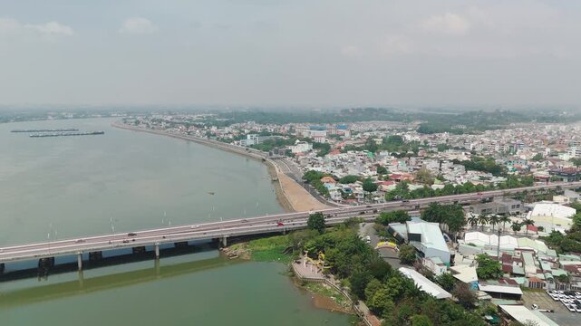 Bien Hoa City, Dong Nai, Vietnam &ndash; 4K aerial drone footage of Dong Nai River, city skyline, riverside neighborhoods, riverside houses, bridge and urban landscape