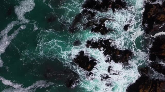 Aerial Horizontal Tracking Top Down Flight over Rough Ocean Waves Crashing Against Rocky Coast, Chile