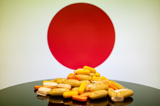 Close up of assorted pills with Japanese flag background.
