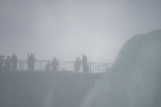American Tourists Viewing Canadian Falls Through the Mist