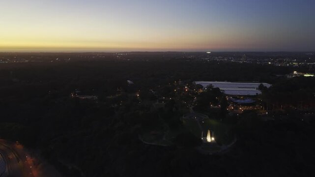 Aerial drone flight over Kings Park at sunset with Perth skyline, Western Australia.  