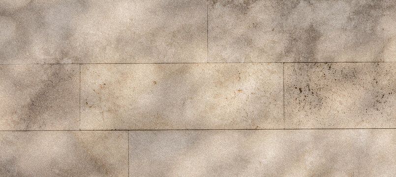 Textured surface of a beige stone tile pattern with subtle variations and an abstract design, ideal for backgrounds or flooring concepts.