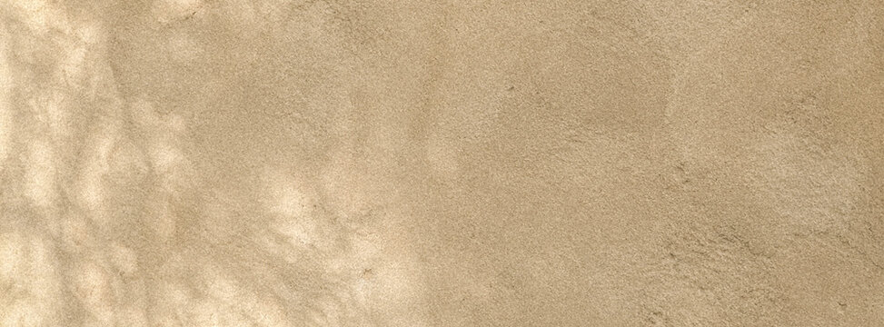 A textured surface displaying a warm beige color, resembling suede or fabric. The subtle variations in tone create an organic and soft appearance.