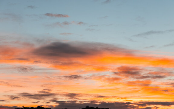Beautiful sunrise sky with some orange colored clouds.