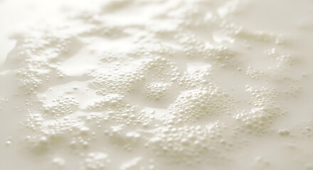 Fototapeta premium Close-up of frothy milk with small bubbles, creating a creamy texture