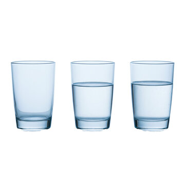 Three identical clear glass tumblers, empty, half-full, and almost full with water, on reflective white studio surface with soft blue light, illustrating optimism and pessimism concept.