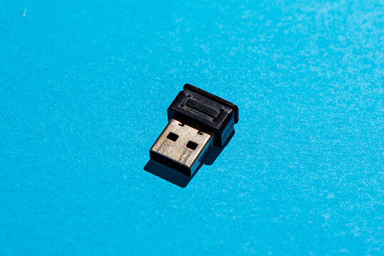 USB wireless receiver dongle on blue background