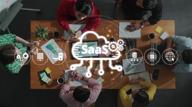 A diverse team engages in a dynamic meeting discussing software as a service solutions, driving innovation and collaboration in a modern office environment. Raster
