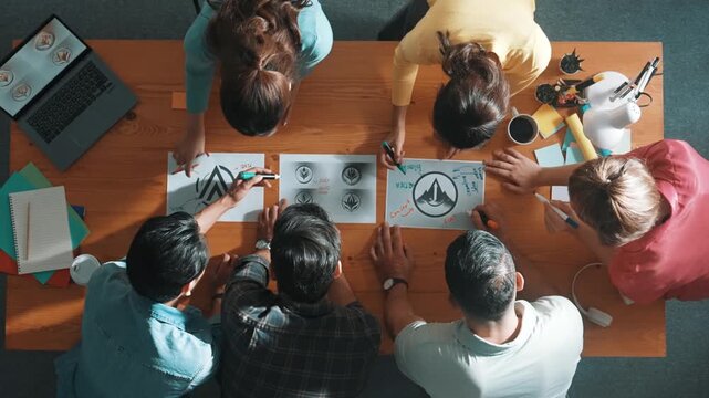 Time lapse of business team write graphic logo on meeting table with colorful sticky notes and design while explain idea. Project manager sharing idea and explain concept art to smart team. Symposium.
