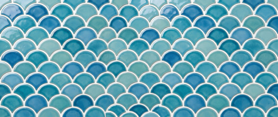 Blue fish scale mosaic tile pattern with glossy ceramic texture creating a seamless coastal inspired background for elegant interiors © UmmeFarhatunnesa