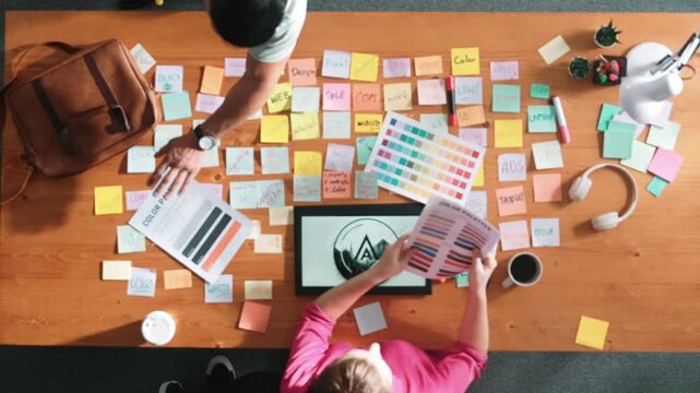 Time lapse of smart business team holding color palettes and choosing color. Professional designer group working brainstorming idea while planning for logo design and looking at tablet. Symposium.