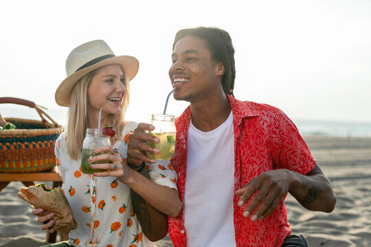 Joyful beach picnic with drinks