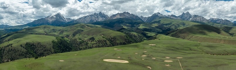 Majestic Aerial Panorama of Mount Genyen Snow Peaks, Glacial Valleys and Alpine Meadows © why2husky