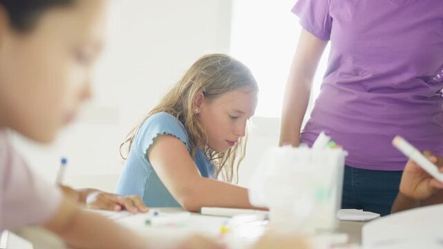 Group of Diverse school children creating arts and crafts together during creative classroom activity developing imagination teamwork fine motor skills and hands on learning in elementary education