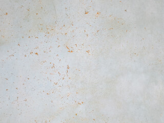 Abstract background of a weathered and distressed wall with peeling paint and plaster in faded light blue and beige tones, showcasing aged texture and grunge details. © Haerudin