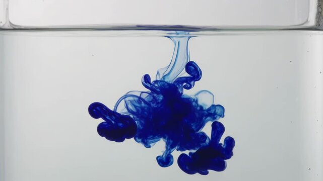 Deep Blue Ink Diffusion Swirling in Transparent Water Creating Abstract Fluid Motion and Artistic Smoke Patterns