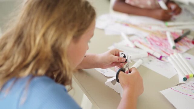 Group of Diverse school children creating arts and crafts together during creative classroom activity developing imagination teamwork fine motor skills and hands on learning in elementary education