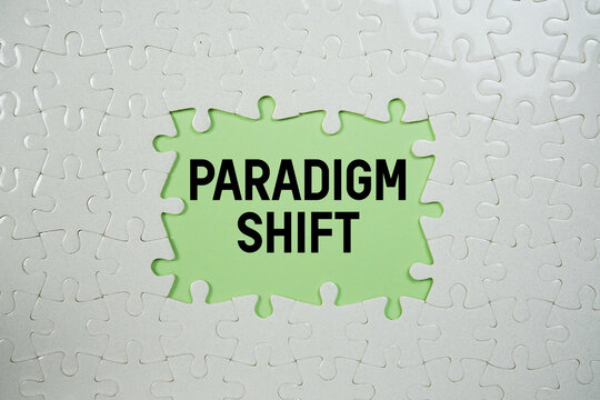 Jigsaw puzzle with a missing piece with "Paradigm Shift" on green background