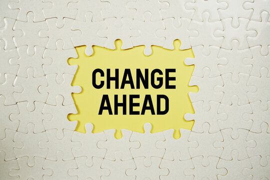 Jigsaw puzzle with a missing piece with "Change Ahead" on yellow background