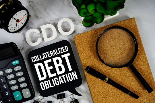 CDO - Collateralized Debt Obligation acronym with calculator, alarm clock and magnifying glass, business concept background