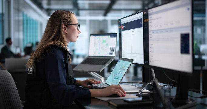 Woman Police Officer Using Computer