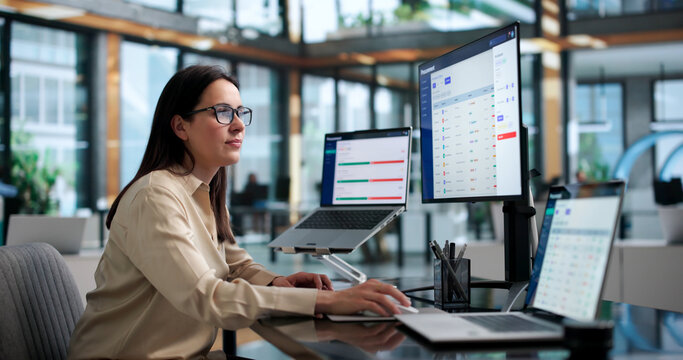 Woman Manager Analyzes Supplier Contracts On Laptop