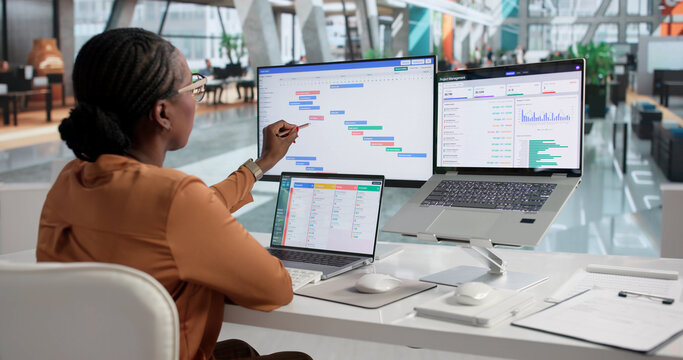 Agile Project Manager Reviews Daily Scrum Tasks Using Laptop