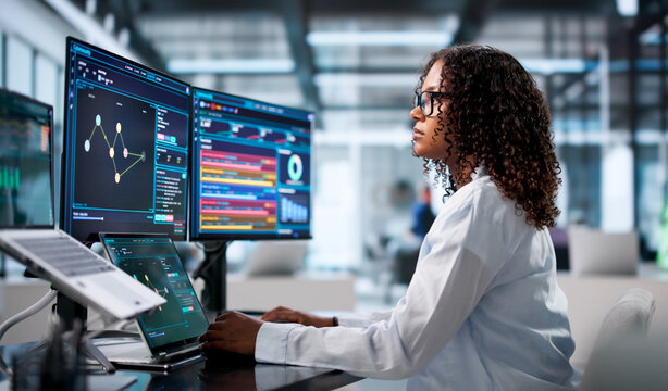 Woman Uses Laptop And Desktop Computers