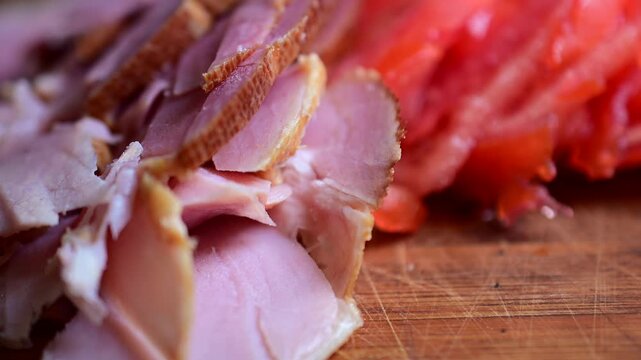 slicing ham cold cut meats cut tomato macro food background video, snacking on it, salt hands, picking up food