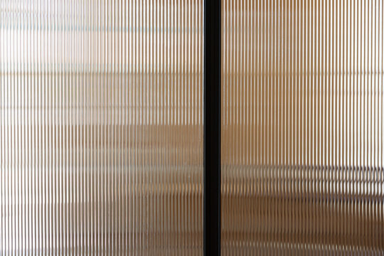 clear polycarbonate plastic background and texture. Transparent material Corrugated plastic surface use for partition wall, door or roofing. close up picture.