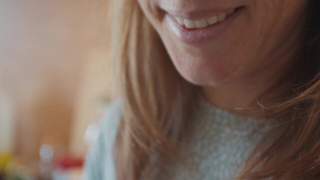 Woman sniffs the morning coffee on the kitchen from the white cup and enjoys its aroma