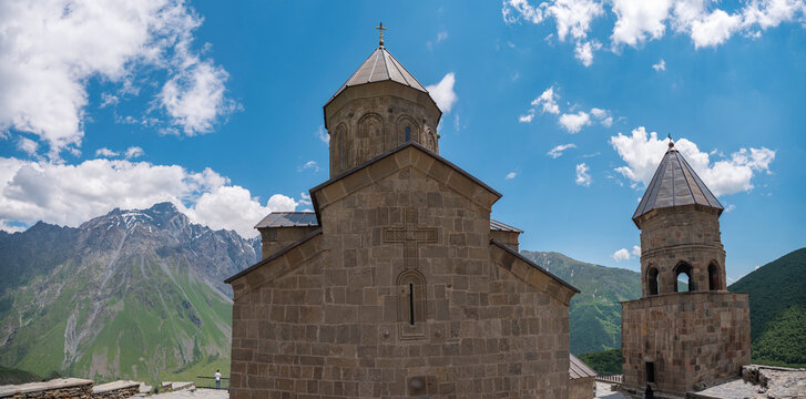 Ancient Gergeti Trinity Church against Caucasus mountains in Georgia with copy space
