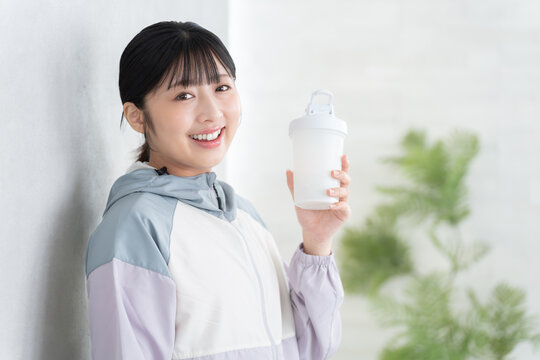 プロテインを飲む女性