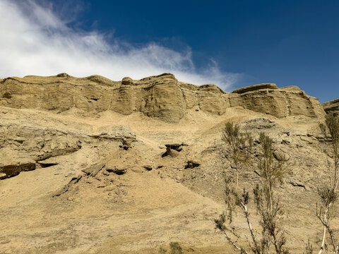 Majestic Yardang landform of Urho Ghost City under a dramatic cloudy sky in Karamay, Xinjiang, China. 