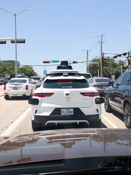 Waymo Jaguar I-PACE Autonomous Vehicle at Traffic Light in Daylight