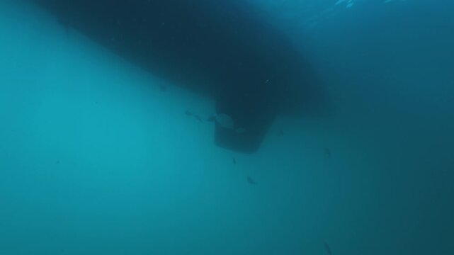 Sailing boat as seen from the bottom of the sea, underwater view of the rudder and keel of a sailing boat