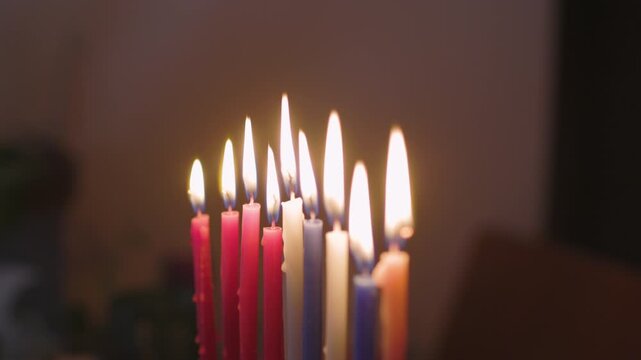  People celebrate Hanukkah by lighting candles on the candle. Jewish festive joy kindles Hanukkah, menora - candles on the sacred Hanukkah. Candles on the Hanukkah. 