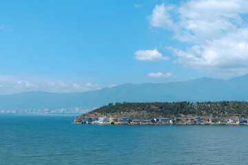 Fototapeta premium Calm coastal island with sea and distant mountains