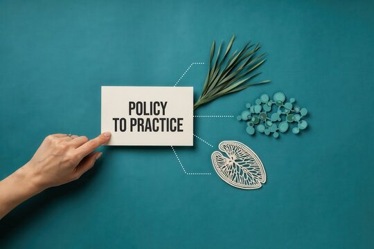 A hand holds a card with policy to practice near a leaf and pills