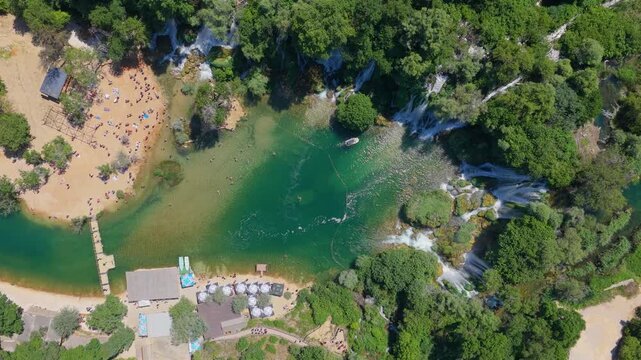 Kravica Waterfall, Bosnia and Herzegovina - June 7, 2026: Top down aerial view of visitors around the famous Kravica Waterfall