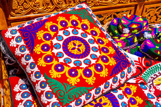 Traditional Central Asian colorful embroidered textile cushion covers with floral pattern at Tajik market, ethnic craft concept