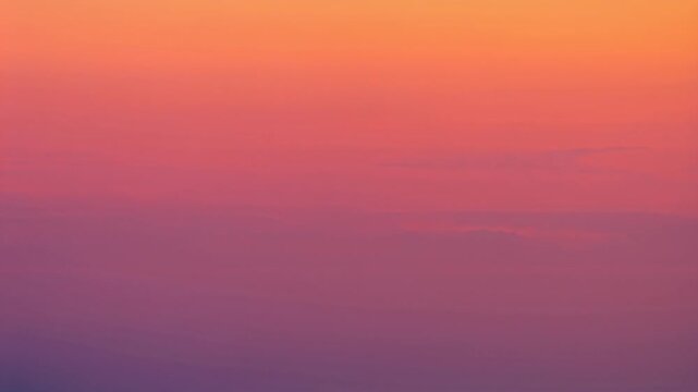 Warm sunset sky gradient with orange pink and purple cloud tones