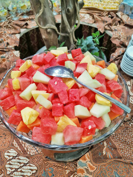 Colorful tropical fruit salad with watermelon pineapple and melon in glass bowl, fresh healthy food concept with vibrant natural colors.