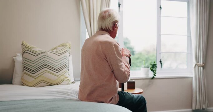 Mental health, thinking or old man on bed with walking stick, mindfulness or insight in nostalgia. Reflection, window or senior person in home with disability, perspective or flashback in retirement.