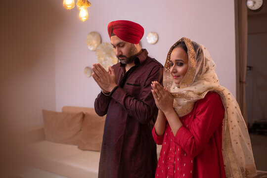 Portrait of Sikh couple praying