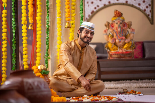 Maharashtrian man decorating home on the occasion of Ganesh Chaturthi
