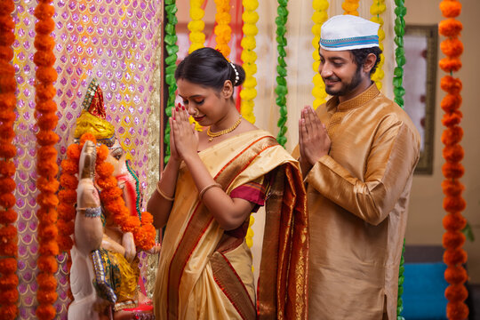 Maharashtrian Couple praying to Lord Ganesha