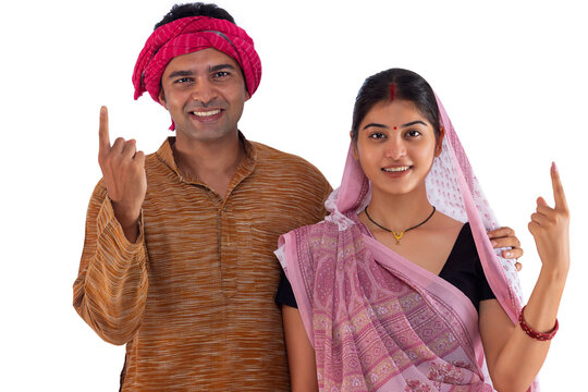 Portrait of Bihar couple pointing above against white background
