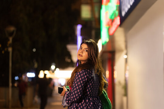 Woman looking back at camera while walking on street